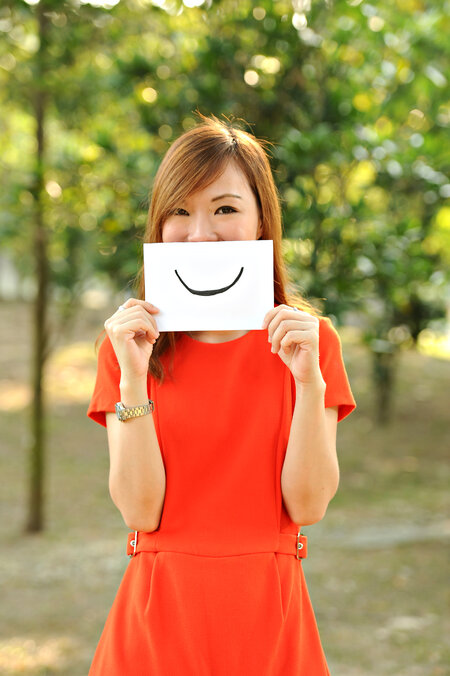 I Am Her: Siew Yen Ng On Finding The Meaning Of Happiness woman holding smiley face card