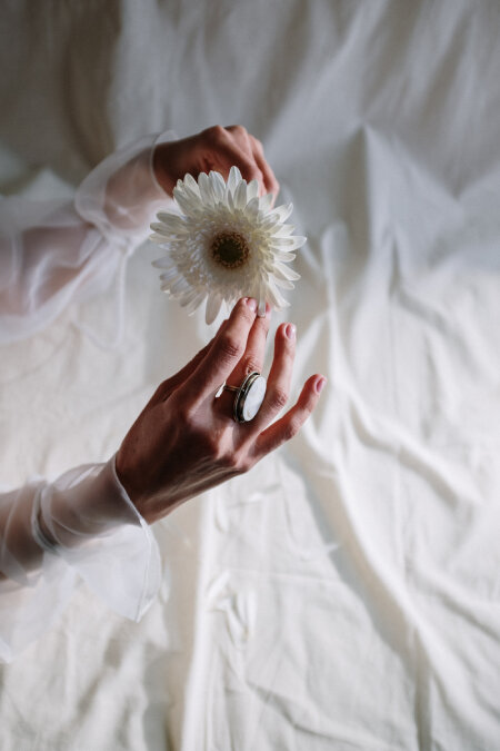 KINOHIMITSU Feminine Care A woman's hands holding a flower