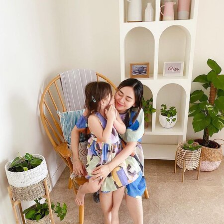 Jenn Low with her child Jenn Low hugging her child