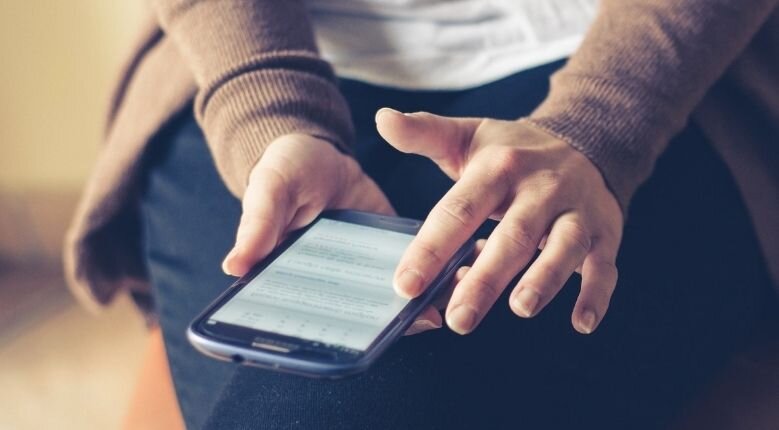 person holding phone person holding phone