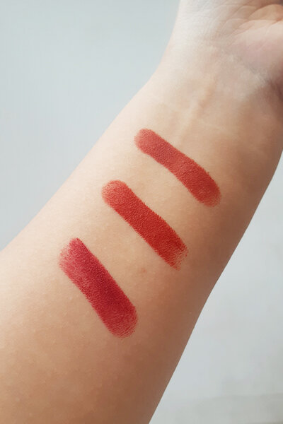 Innisfree Vivid Cotton Sticks Arm Swatches A close-up of Innisfree Vivid Cotton Sticks swatches on reviewer's arm