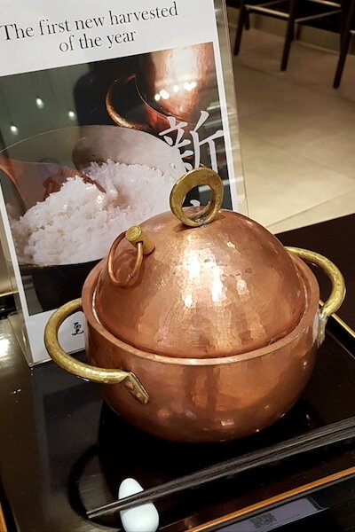 A copper pot carrying fluffy rice