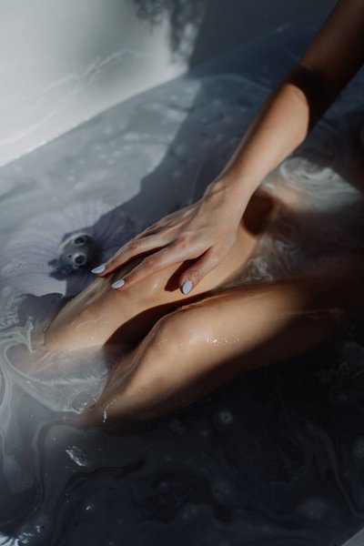 Woman in bathtub with clear water
