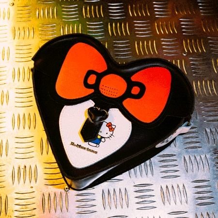 A photo of the heart-shaped mini bag in the Dr. Martens x Hello Kitty Collection