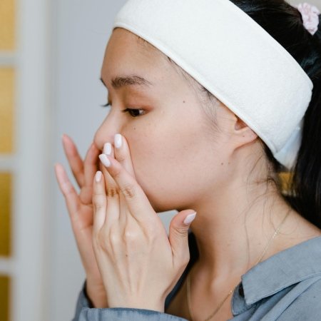 woman applying a japanese skincare lotion to her face