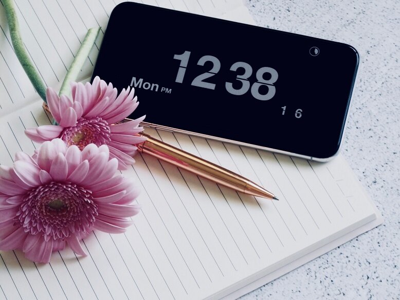 Photo of a phone with clock and pink flower The Five Second Rule moves you to do it now, rather than later.