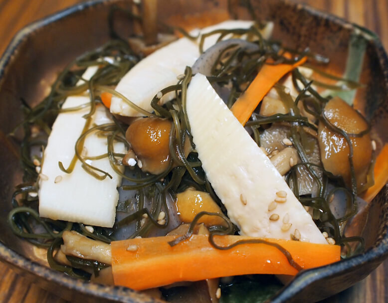 Nimono (simmered dish) with kombu, bamboo shoot, konnyaku and nameko.