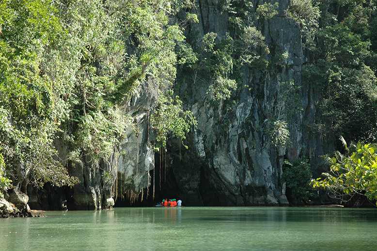 A boat entering an underground river