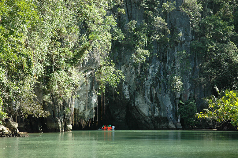 A boat entering an underground river