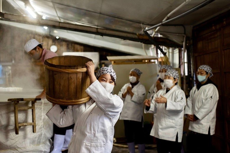 Woman carrying fermented sake 
