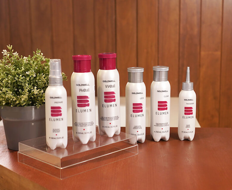 White bottles of hair products on table