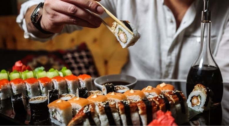 Man eating Japanese rolls