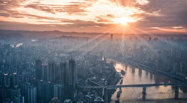 Optimism is key Sunset shining over city