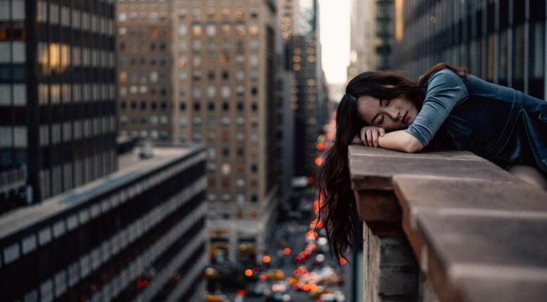 February ups and downs Woman resting her head on a balcony