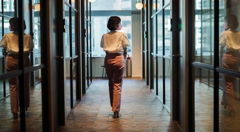 woman walking in office corridor