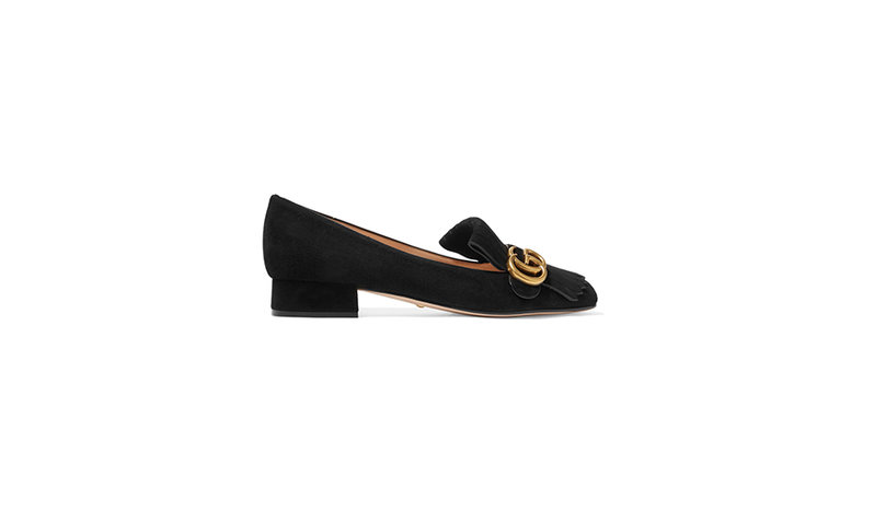 A fringed Gucci-logo embellished black suede loafer