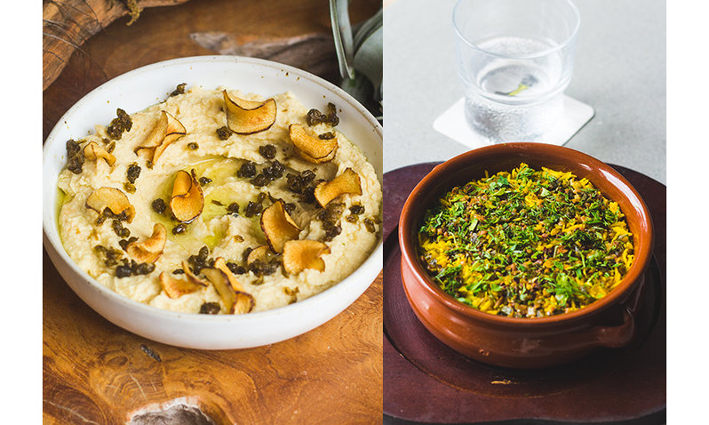A bowl of a mashed hummus-like dish, and a bowl of greens