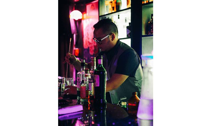 A bartender mixing cocktails